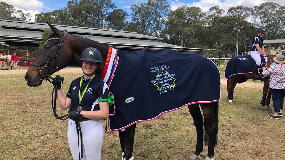 CHAMPION: Hannah Wigg with her horse Lily after collecting their national title ribbons at the National Pony Club Championships. Picture: CONTRIBUTED