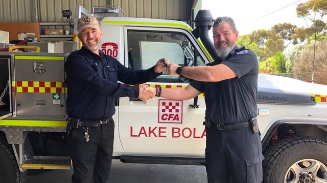 Brigade captain Lyndon Varney accepting the keys from District 16 operations manager Bernie Fradd. Picture: CONTRIBUTED
