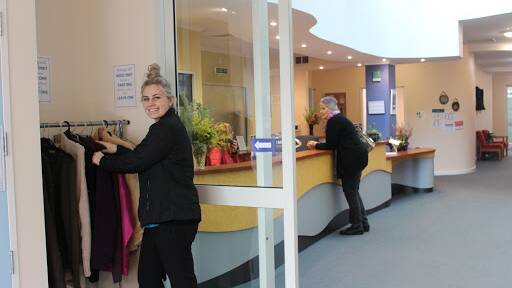 KEEPING WARM: Grampians Community Health admin support Chloe Wilson sorting out the coat rack at Stawell reception area. Picture: CONTRIBUTED