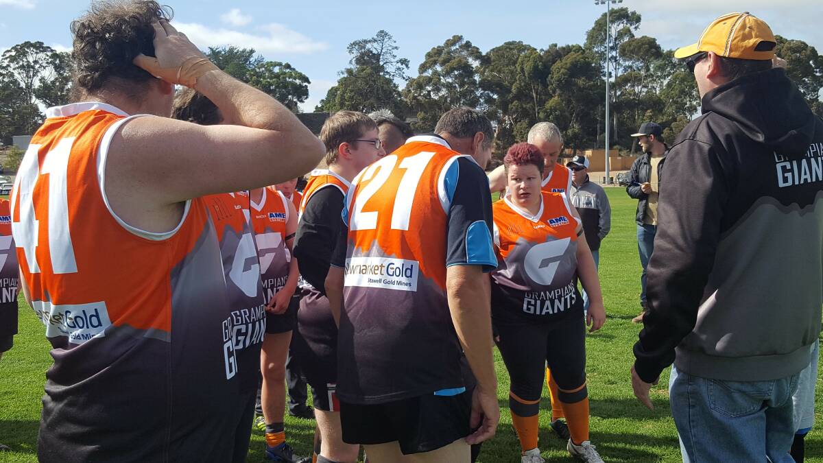 The Grampians Giants in a huddle at half time against South Warrnambool Hurricanes in their round two match.