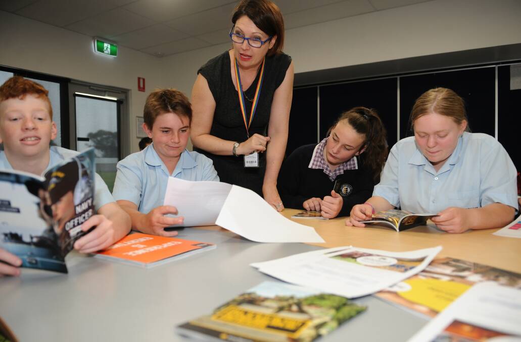 CHOICES ABOUND: Horsham College careers adviser Caroline O’Donnell with Year 8 students looking at careers brochures. Picture: CARLY WERNER