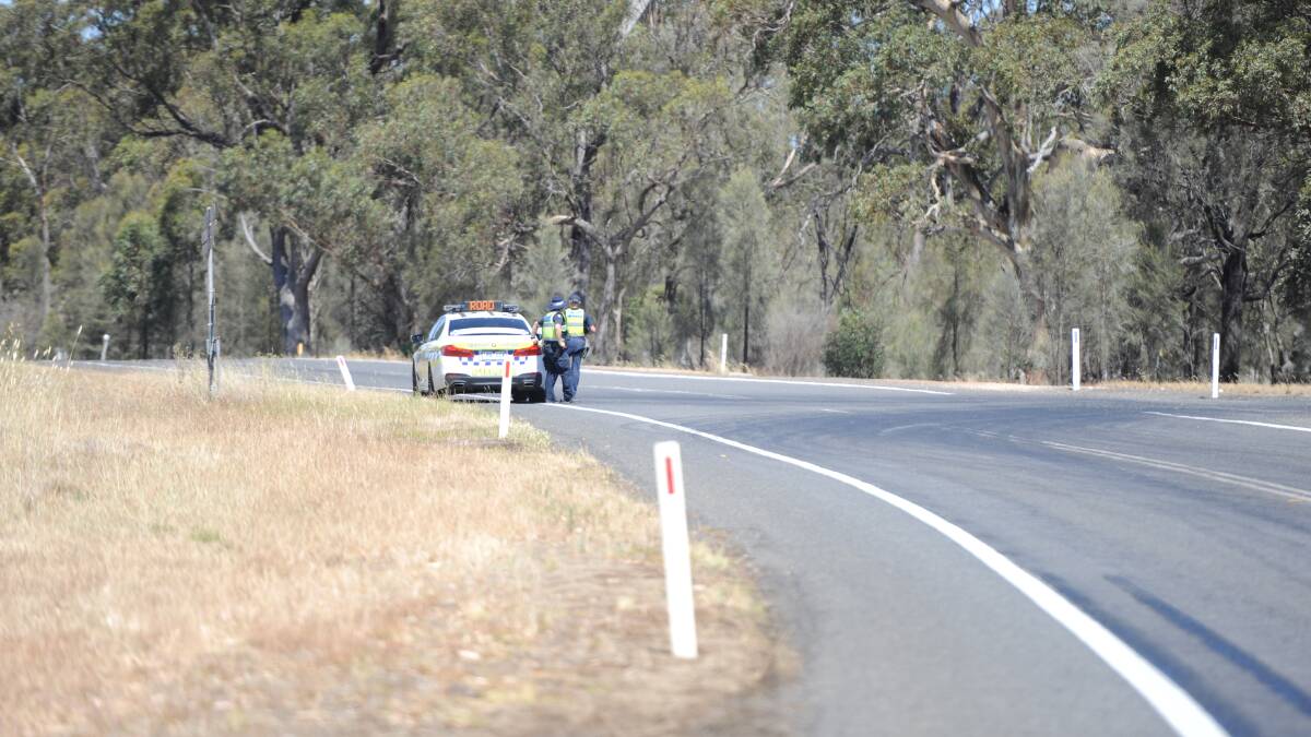 Police roadblock at the northern end of the Henty Highway fire at Cherrypool on Tuesday afternoon. Picture: ALEX DARLING