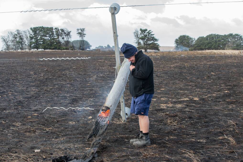 Action: The Sisters farmer Jack Kenna with the snapped power pole which caused The Sisters/Garvoc fire. Picture: Christine Ansorge