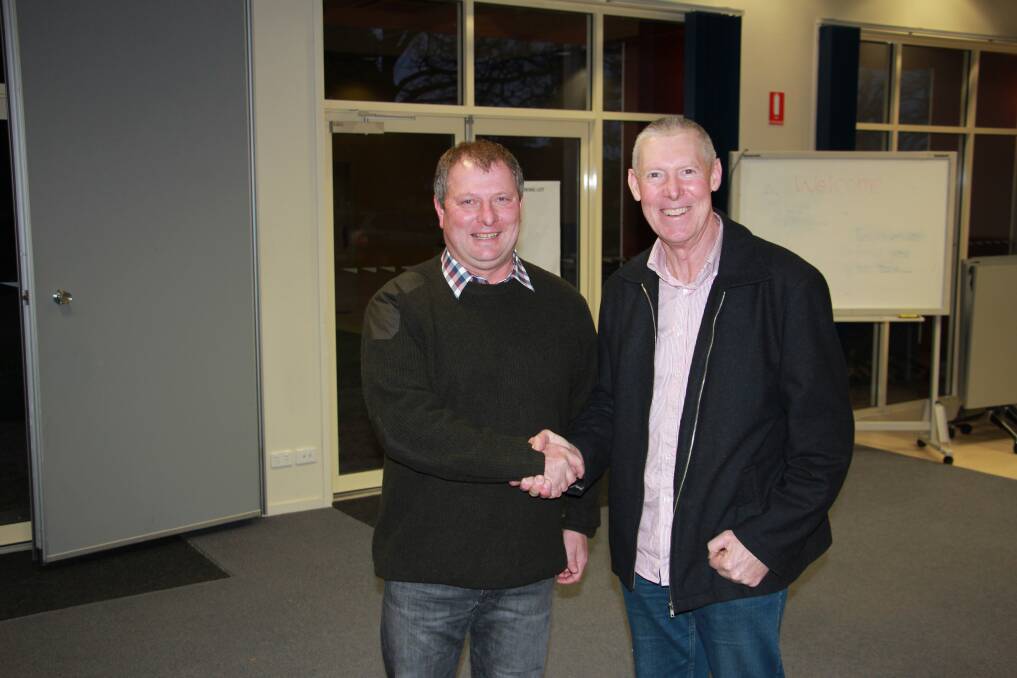 Pyrenees Shire Council's newest councillor Damien Ferrari shakes hands with shire mayor David Clark. Picture: CONTRIBUTED