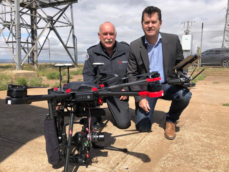 CFA community engagement coordinator west region Chris Carey and Telstra regional general manager Steve Tinker test out the new equipment at Mount Hollowback on Wednesday. Picture: Greg Gliddon
