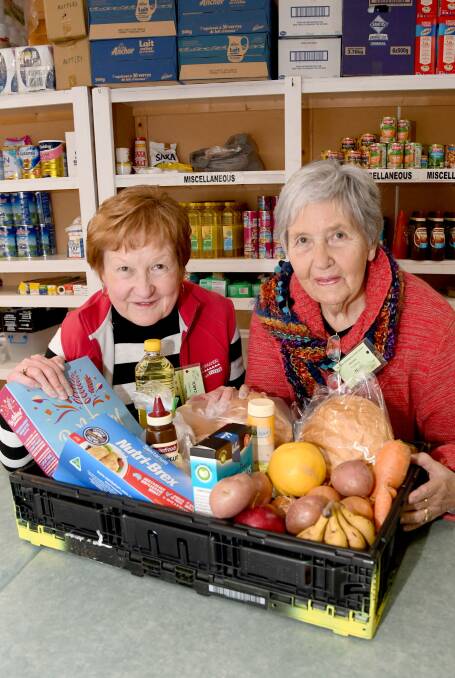 FOOD INSECURITY CONCERNS: Horsham Christian Emergency Food Centre volunteers Carol McDonald and Jean Combe with a range of food available at the centre. Picture: SAMANTHA CAMARRI