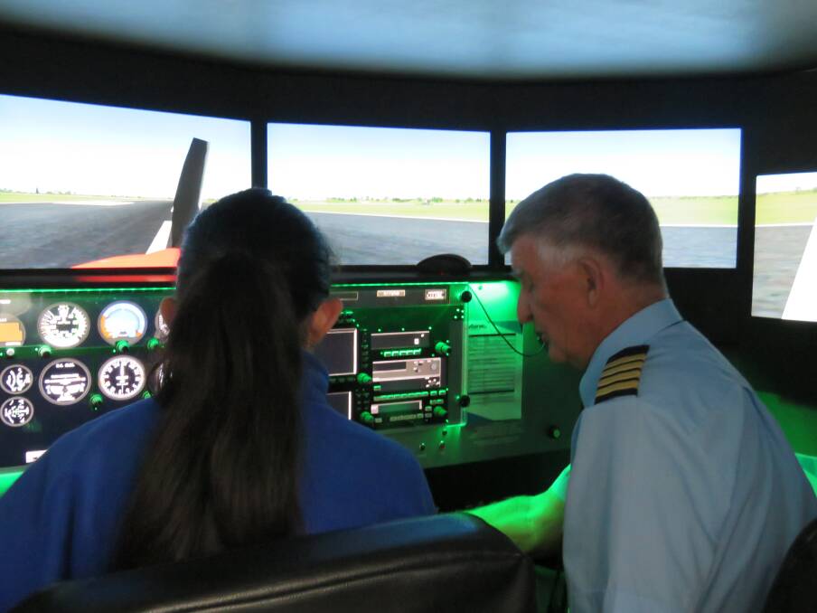 LIFT OFF: An AvServe officer teaches a year 10 student the basics of flight simulator. PICTURE: Supplied.