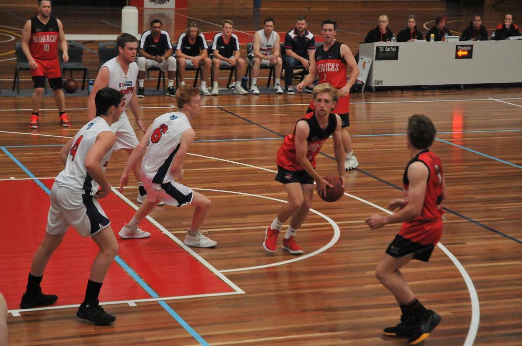 FINALS CHANCES: Ararat Redbacks' Will Lawrie looks to find a teammate against the Horsham Hornets in December. Picture: CASSANDRA LANGLEY.