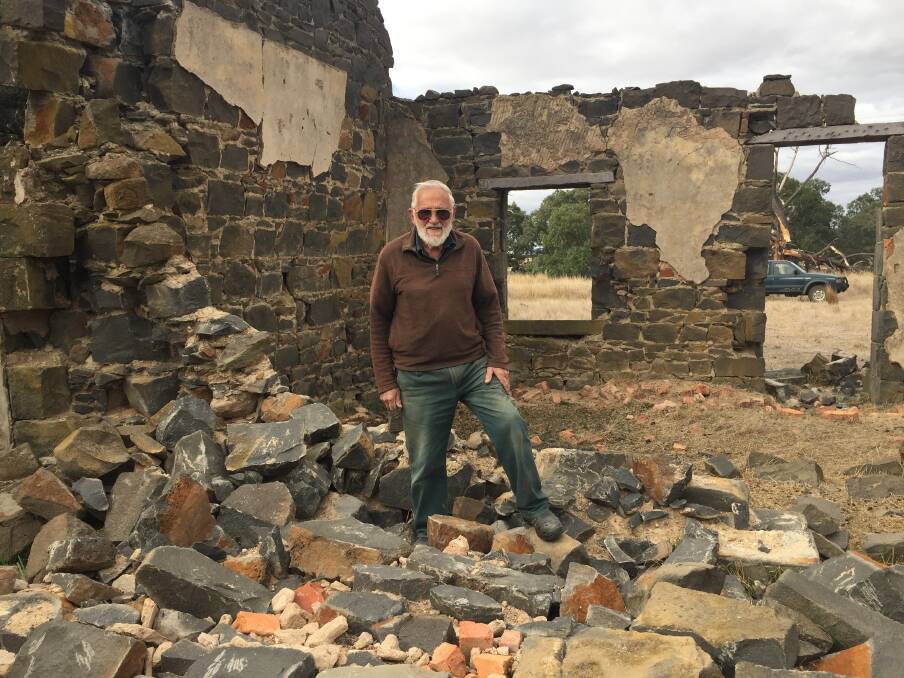 DESTROYED: Property owner Max Wohlers stands on the remains of the wall of his historic property, which thieves smashed in order to steal bluestone blocks. 
