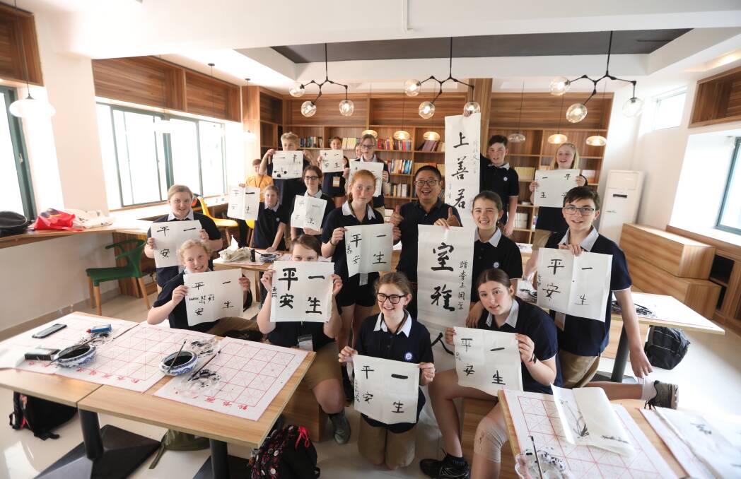 Students on a sister school China trip in calligraphy class at Yancheng Middle School. Picture: CONTRIUBTED. 