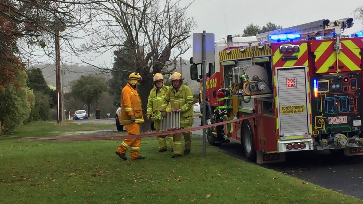 Ararat Fire Brigade members prepare to assist an Ararat resident after smoke was reported issuing from a central heating unit. Picture: JESSIEANNE GARTLAN. 