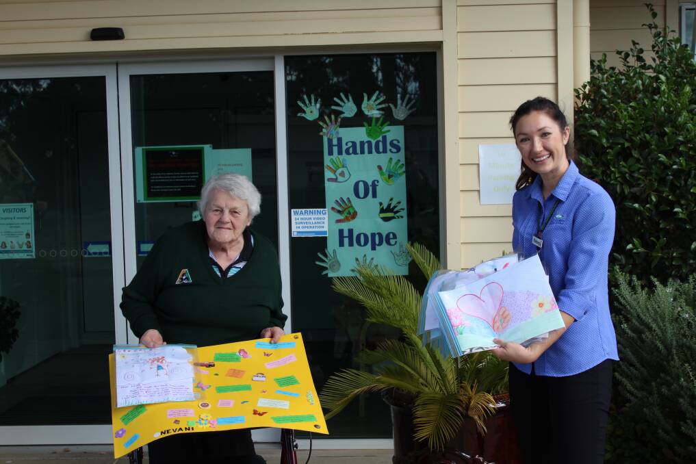 DELIVERING KINDNESS: East Grampians Health Service health promotion officer Kelsey Weight delivering mail to Jean. Photo: CONTRIBUTED.