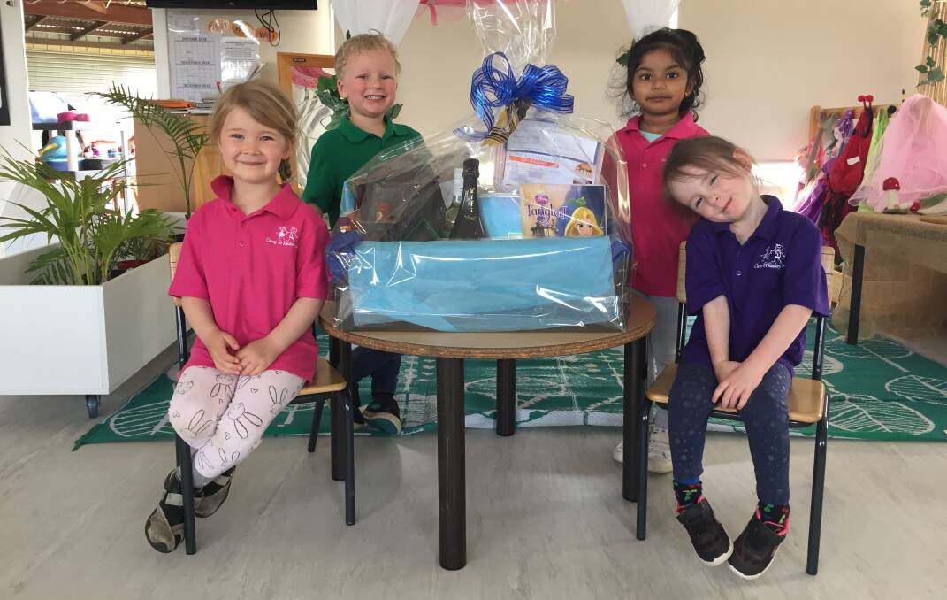 PRIZE: Finlay, left, Theo, Siyathma and Delilah surround the first prize for the Carey Street Kindergarten Fair fundraiser raffle.
