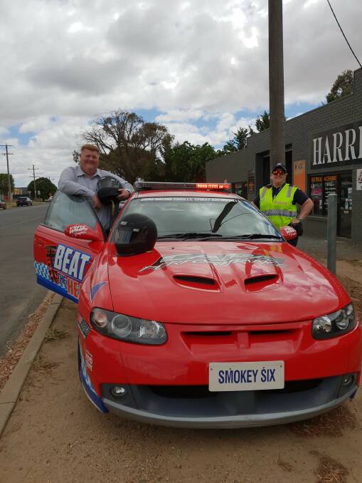 STREET SMART: Ararat Rural City Council chief executive Dr Tim Harrison with Senior Constable Danielle Richardson and 'Smokey Six', the Beat the Heat car.