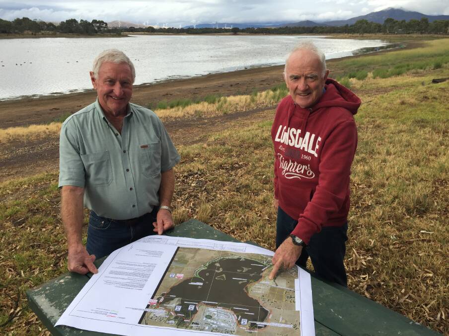UNDERWAY: Rod Smart and John Hunt with their plan for Green Hill Lake Reserve.