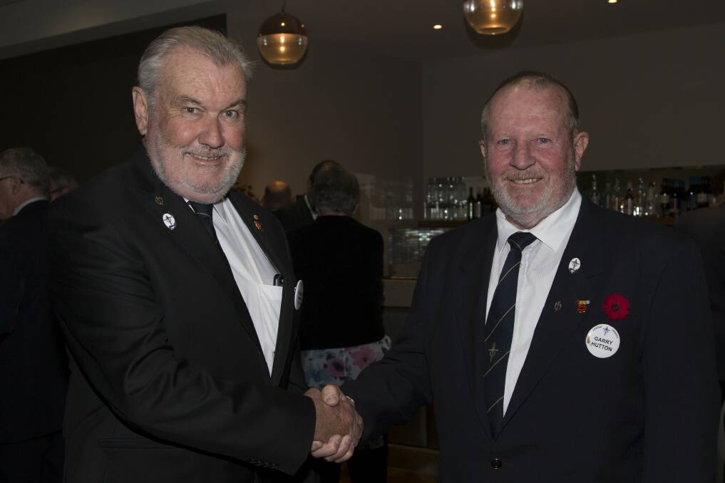Outgoing president Robert Irvine welcomes incoming president Garry Hutton. Picture: PETER PICKERING. 