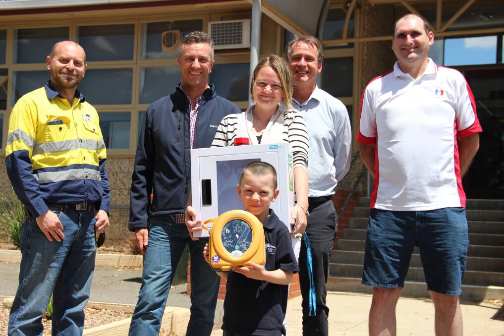 Bulgana site manager Andrew Ferres and construction project manager Stephen Thompson, parent Jessica Jones, Stawell West principal Jim O'Brien, parent and Heartkids member Russel Holmes and student Kane Holmes (front) with the school's new defibrillator. Picture: LACHLAN WILLIAMS