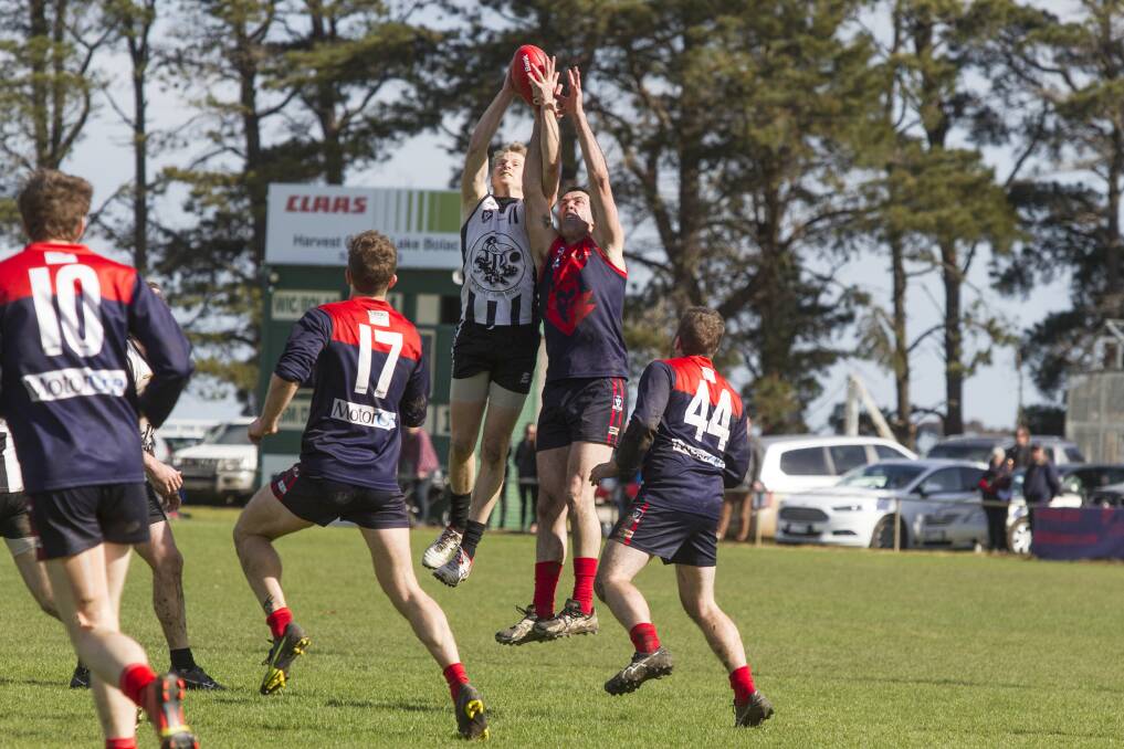 BATTLE: Magpie Brad Keilar and Demon Tim Turner in a contest in the 2017 Mininera District Football League grand final. Picture: Peter Pickering.