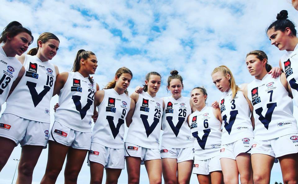 DOING THE JUMPER PROUD: Georgia Clarke (number 25) and her Victoria Country teammates after a win at the national championships. Picture: TAC Cup.
