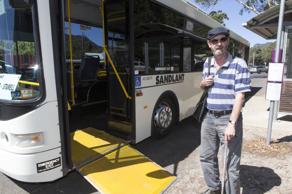 Regular bus user Colin Machin boards a bus at Halls Gap. Picture: PETER PICKERING