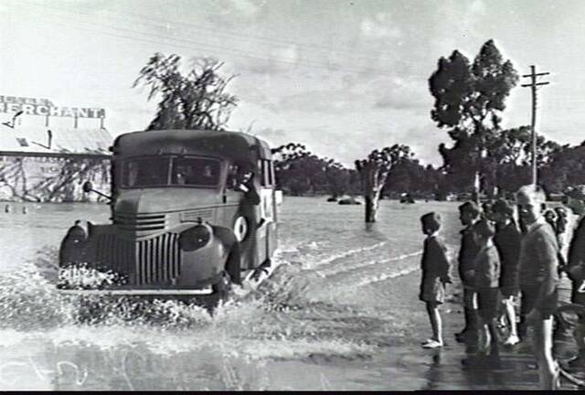 WAR EFFORT ON THE HOMEFRONT: A WAAF recruiting van ploughs through a flooded Firebrace Street in 1942. Picture: AUSTRALIAN WAR MEMORIAL