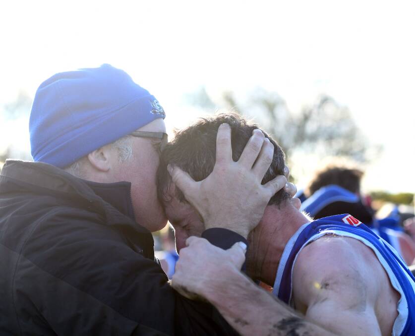 John Delahunty shares a moment with brother Chris after the final siren. Picture: MATT CURRILL