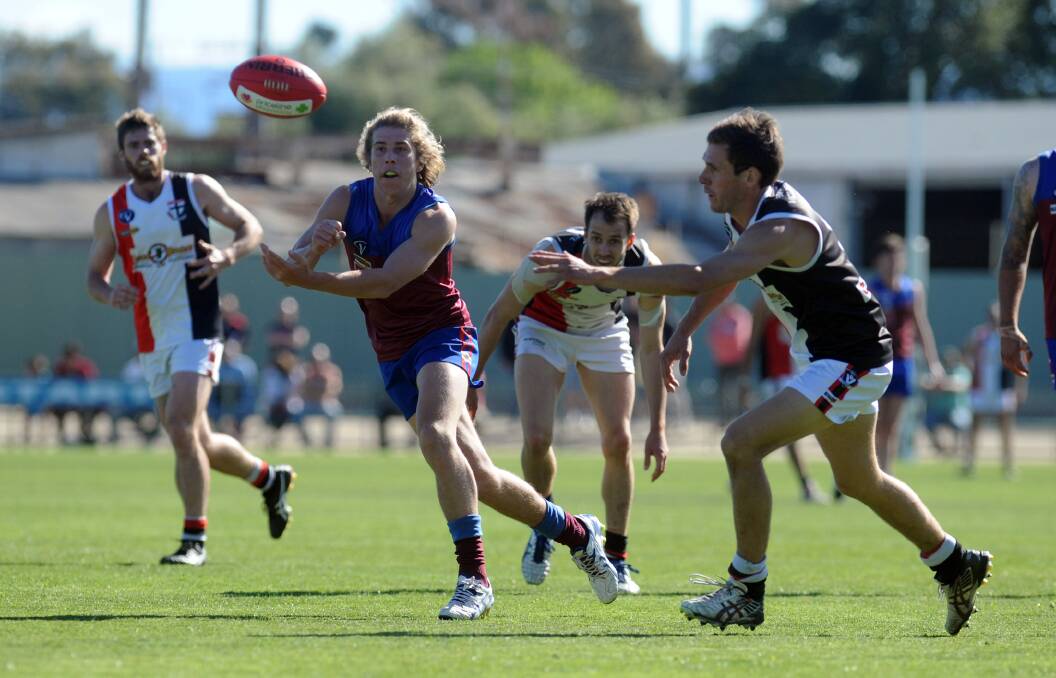 Billy Lloyd moves the ball on in the 2014 grand final. 