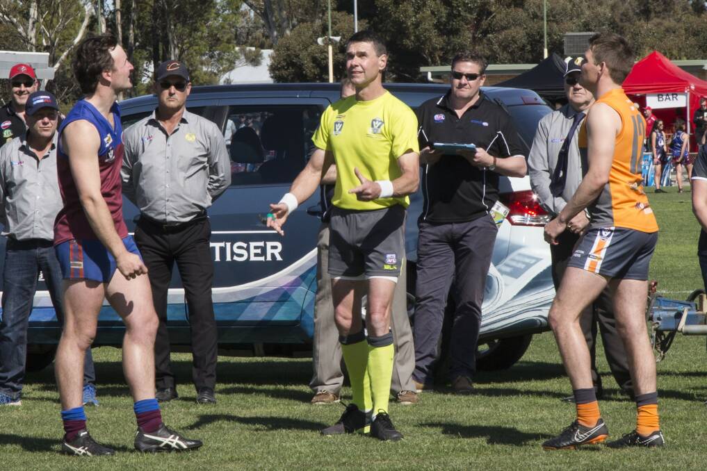 Umpire Gerald White tosses the coin in last season's WFL grand final. Picture: PETER PICKERING