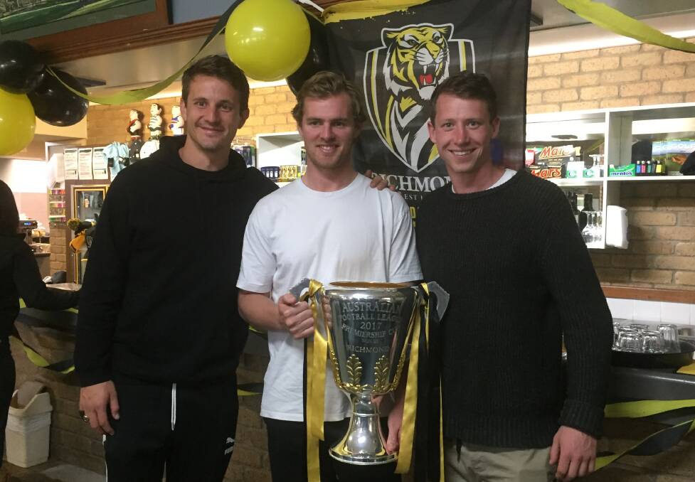 PREMIERS: Richmond's Ivan Maric, David Astbury and Dylan Grimes with the 2017 AFL Premiership Cup at the Chalambar Golf Course.