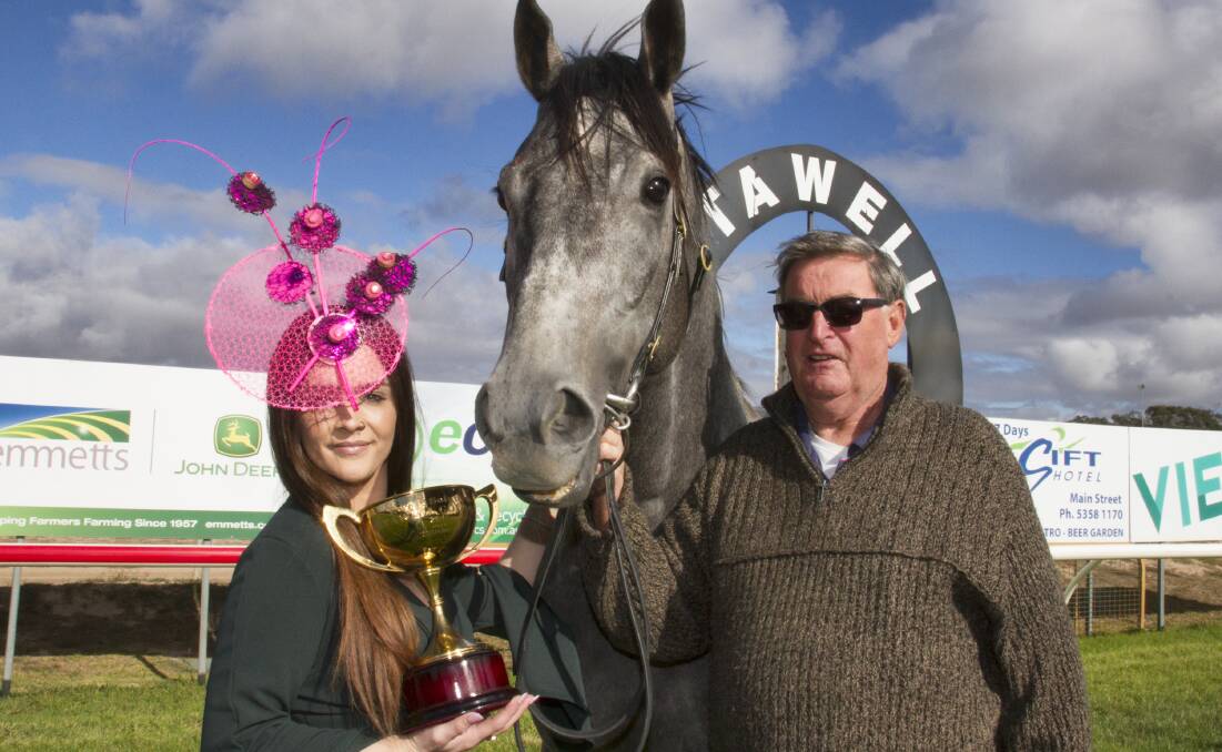 Madi Deutsher and trainer Terry O'Sullivan pose with the Stawell Gold Cup. Picture: PETER PICKERING
