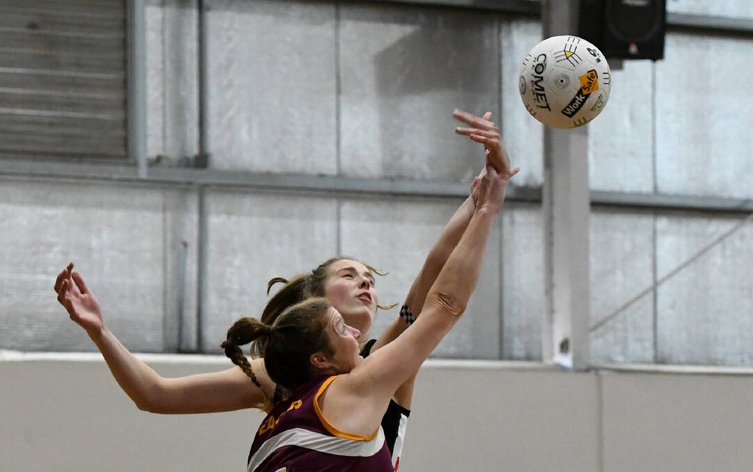 Maggie Caris and Jess Kelly compete for the ball. Picture: SAMANTHA CAMARRI