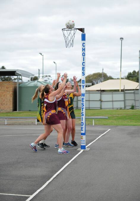 Warrack Eagles and Dimboola players jostle for the best position as they wait for the rebound. Picture: MATT CURRILL