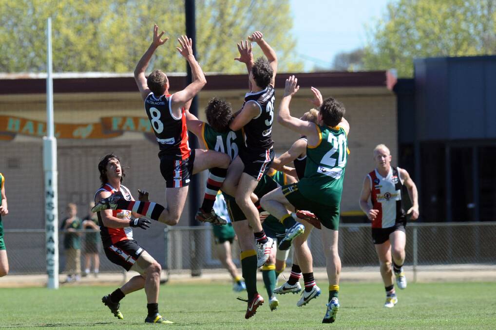 A pack of players fly for a mark during the 2014 reserves grand final. 