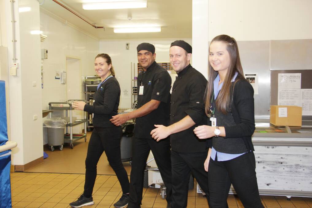 ACTIVE: Exercise physiologists Zosha Jarecki-Warke (left) and Sarah Wardle (right) step it out with kitchen staff Naveen Mettu and Will Bell. Picture: CONTRIBUTED