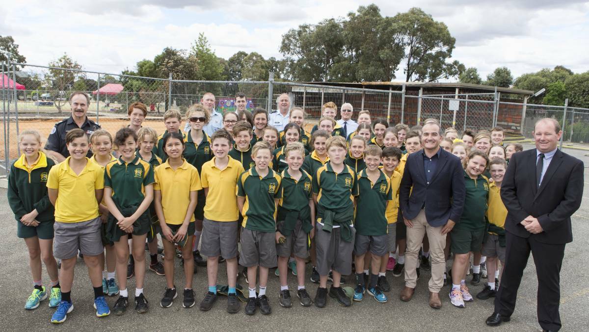 Victorian Education Minister James Merlino joins with CFA volunteers and Ararat West Primary School principal Tony Keilar and pupils in November. Picture: PETER PICKERING