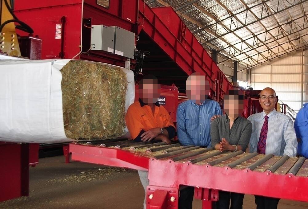 UWE managing director Jimmy Liu (right) with employees and suppliers at the company's hay packing operation outside Leeton in 2015. Picture: Farm Online