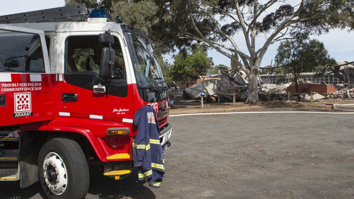 Fire investigators at the scene of Ararat West Primary School, where four classrooms caught fire in October. Picture: PETER PICKERING