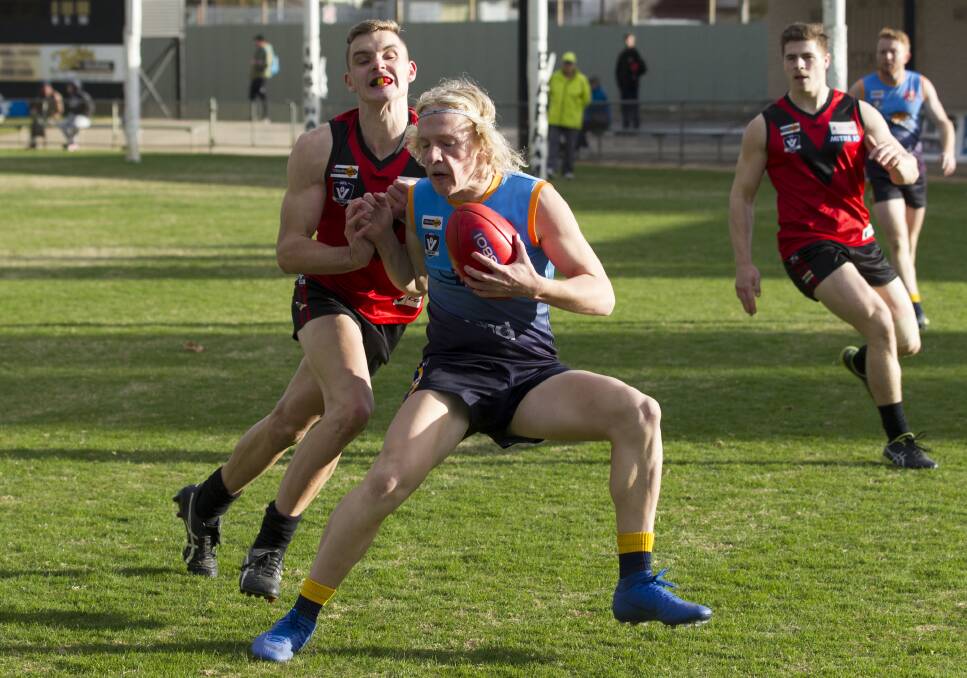 Stawell Warriors' Sam Chatfield tries to tackle Nhill's Drew Schneider. Both were invited to the Rebels testing day. Picture: PETER PICKERING