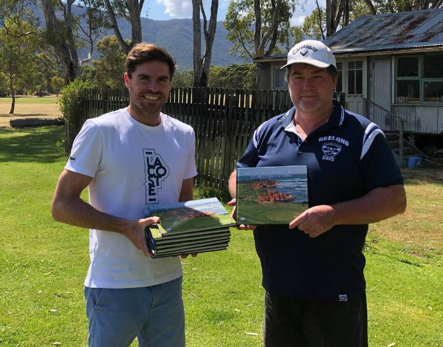 AN HONOUR: Author Henry Peters and Halls Gap Golf Club's Neill McIntosh with editions of Honesty Box Golf Courses of Western Victoria. Halls Gap features in the coffee table book. Picture: CONTRIBUTED
