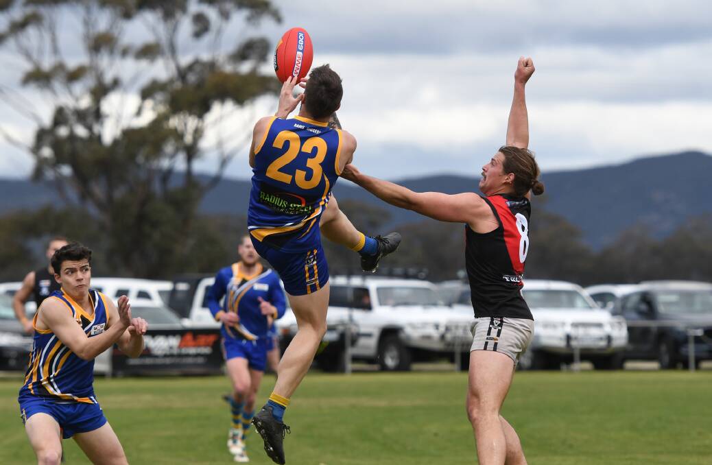 Natimuk United's Mitch Riddell flies for a grab against Noradjuha-Quantong's Dustin Cross. Picture: SAMANTHA CAMARRI