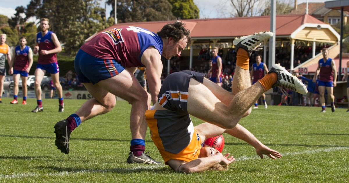 Horsham's Rhona Conboy offloads Southern Mallee Giant forward Nicholas O'Farrell in the semi-final. Picture: PETER PICKERING