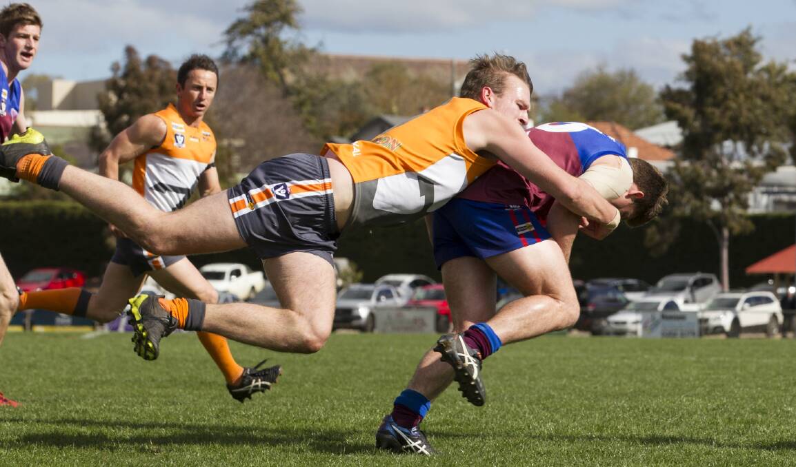 Josh Webster launches a flying tackle on Brodie Mines in the first final against Horsham. Picture: PETER PICKERING