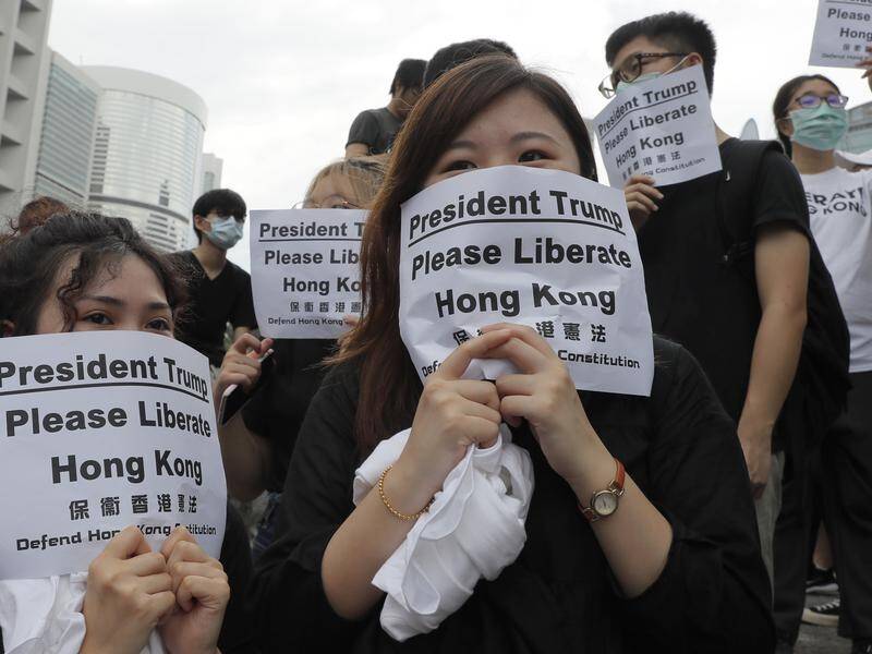 Protesters in Hong Kong have marched on foreign consulates calling for the G20 to liberate the city.