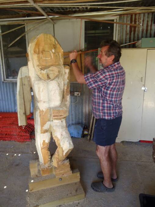 Frank Deutsch works on a wood carving of a member of the Bulugbara tribe for the Lake Bolac Eel Festival.