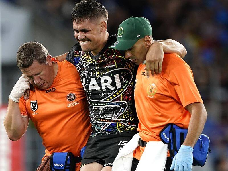 Chris Smith is helped off the field during Saturday's Indigenous All Stars-Maori Kiwis match.