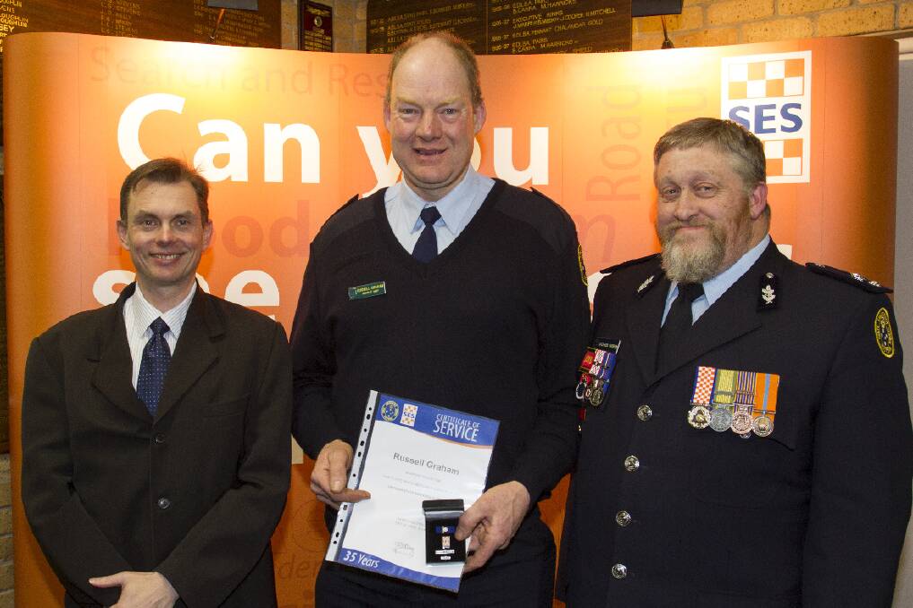 Russell Graham (centre) was acknowledged for his 35 years of service by John Casey director of corporate services and SES regional manager Stephen Warren. Pictures: PETER PICKERING