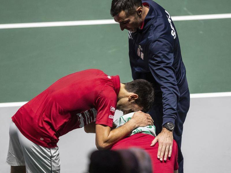 Novak Djokovic (l) and captain Nenad Zimonjic, comfort Viktor Troicki after their defeat to Russia.