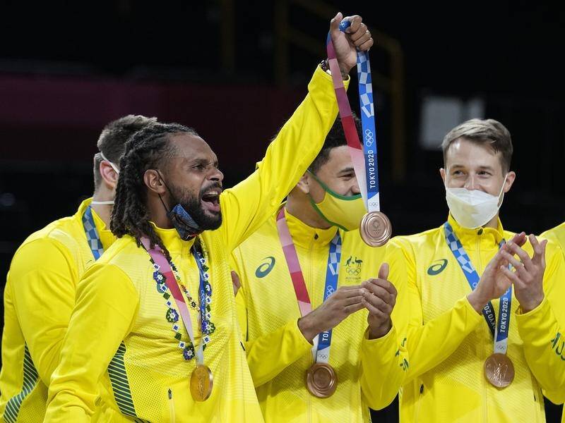 Patty Mills holds up an Olympic bronze medal that means so much to Australia's men's basketballers.