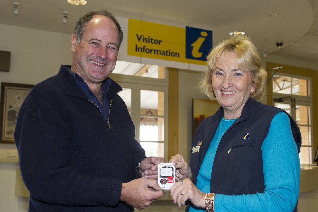 Tourist Information volunteer Lenore Grice happily accepts a medalion from Mayor Paul Hooper