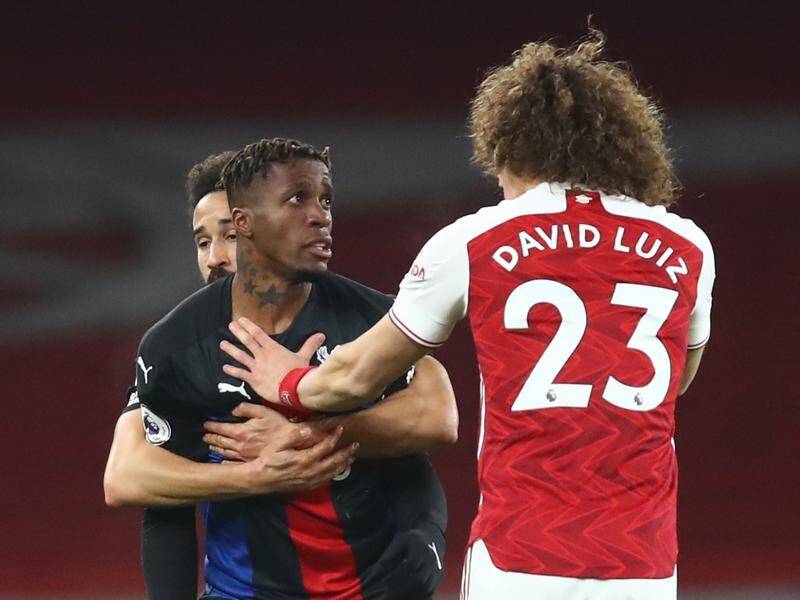 Crystal Palace's Wilfried Zaha and David Luiz of Arsenal argue during Thursday's goalless EPL draw.